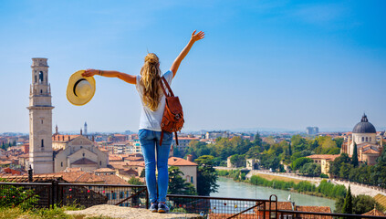 Happy traveler girl in Verona- panoramic view of cityscape in Italy