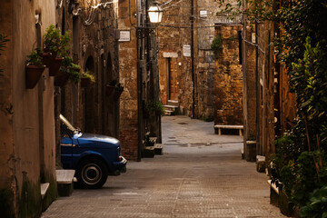 Blue car on the streets in the old town Pitigliano