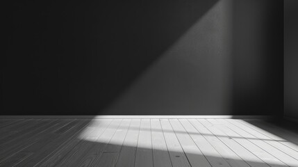 A minimalistic, empty room with dark walls and wooden floor, illuminated by sunlight streaming through a window, creating a serene atmosphere.