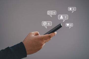 Man using smartphone typing Live chat chatting and social network concepts, chatting conversation working on mobile phone in chat box icons pop up. Social media marketing technology concept.