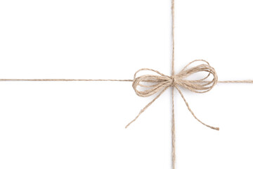 Linen rope string with bow isolated on white, top view