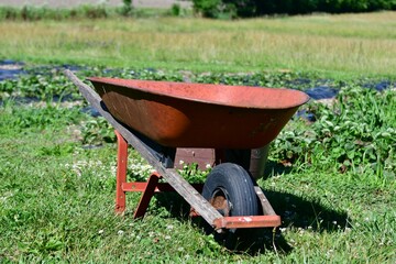 Wheelbarrow by a Garden