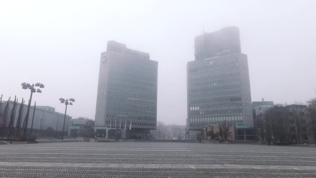 Ljubljana, Slovenia, with fog enveloping Trg Republike (Republic Square), creating a mysterious and atmospheric scene in the heart of the city.






