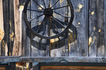 Covered Wagon Wheel Hung On Wood Barn