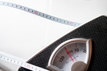 Naklejka premium Bathroom scale and measuring tape for weight tracking