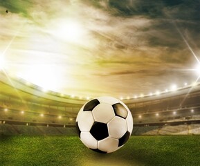 Classic soccer ball on green field in stadium
