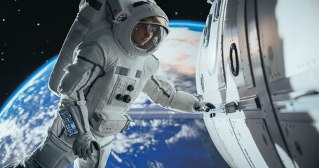 Astronaut on an Extravehicular Mission in Outer Space. Courageous Man Holding by the Handle, Inspecting the Space Station During a Service Procedure. Blue Planet Earth Rotating in the Background