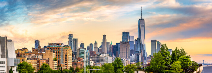 Panoramic view of Lower Manhattan skyline at sunset, behind the Little Island public park.
