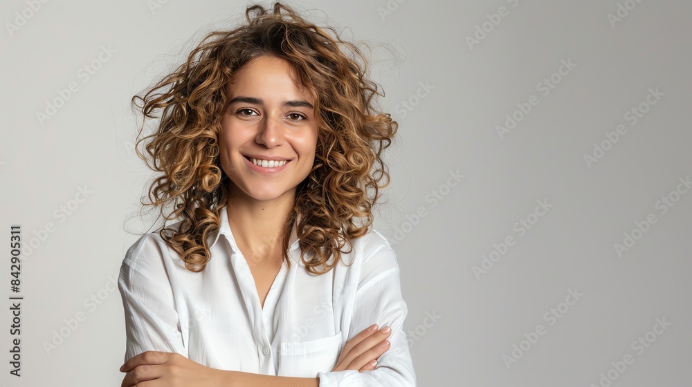 Sticker Smiling woman with curly hair, arms crossed, plain white background, casual look, isolated, friendly and relaxed, copy space