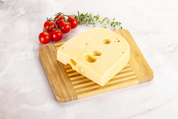 Maasdam cheese brick over board