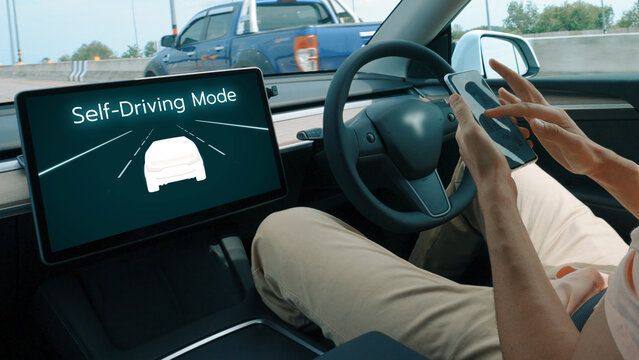 Self driving car or autonomous vehicle travel on speed highway with driverless system and autopilot mode allowing man driver relax and focus on smartphone without compromising safety. Perpetual - Powered by Adobe