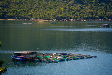 Obraz premium Aerial view of the lobster feeding farms, float fishing village in Vung Ro bay, Phu Yen, Vietnam. This is a very popular tourist destination.