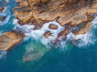 Aerial drone top view of beautiful waves crashing on the rocky island coast, ocean waves and fantastic. Ocean in Vietnam.