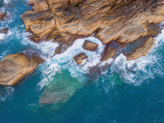 Aerial drone top view of beautiful waves crashing on the rocky island coast, ocean waves and fantastic. Ocean in Vietnam.