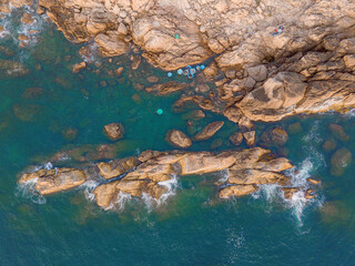 Aerial drone top view of beautiful waves crashing on the rocky island coast, ocean waves and fantastic. Ocean in Vietnam.