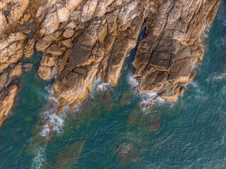 Aerial drone top view of beautiful waves crashing on the rocky island coast, ocean waves and fantastic. Ocean in Vietnam.