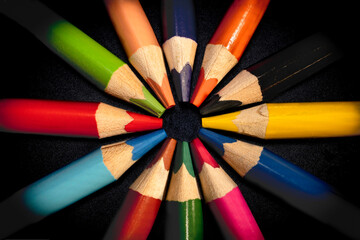 Colored pencils on black background