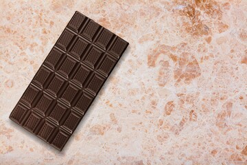 Bitten tasty sweet milk chocolate on the desk