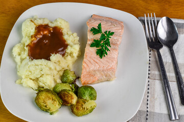 baked salmon  top with parsley  and a side of mash potatoes,