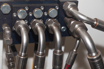 High pressure hydraulic hose system connected to steel pipes, close-up. Marine hydraulics.