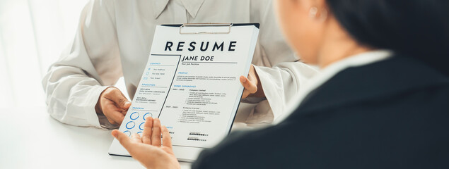 Corporate recruiter interview job applicant to discuss career goal and assess resume and...