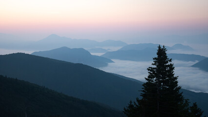 Valley full of fog surrounded by mountains during colorful sunrise, shot in Slovakia, Europe