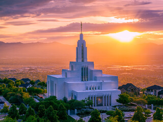 Clouds form rays of sunshine behind the Draper Utah Temple