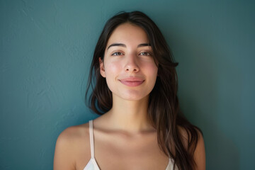 A close up portrait of a young woman with a subtle smile