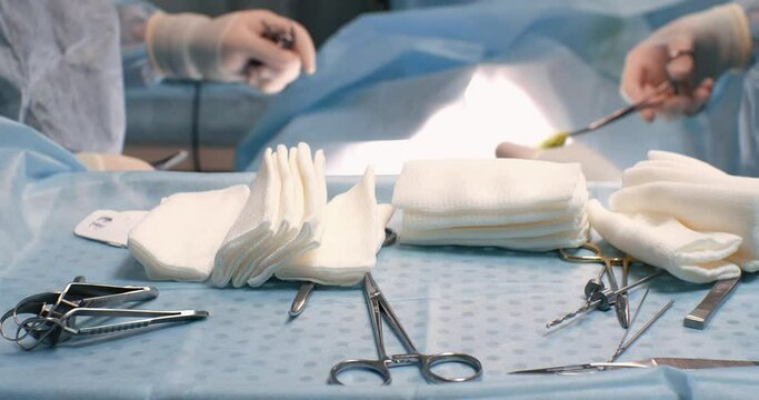 Table with surgical instruments in the operating room. During an operation on a pet in a veterinary surgery, a sterile instrument is laid out on the table. Surgical instrument concept.