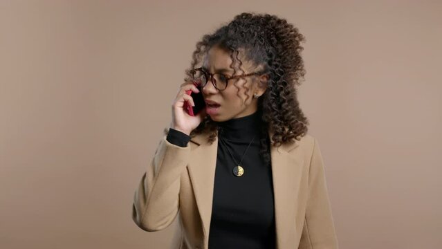 Angry african student teen lady quarreling talking mobile phone. Girl in stress.
