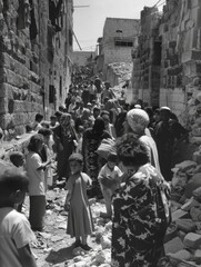 a black and white photo of people standing in a narrow alley