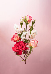 bouquet of red roses and white flowers on light background