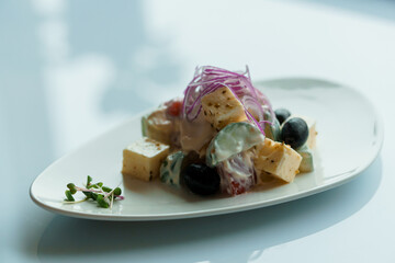 Salad with herbs hard cheese black olives cherry tomatoes onion cucumber