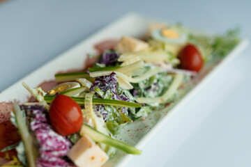 Salad with herbs hard cheese black olives cherry tomatoes onion cucumber