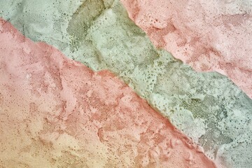 Fototapeta premium Captivating background with rough textured wall in pink and green, separated by diagonal line for modern, urban projects