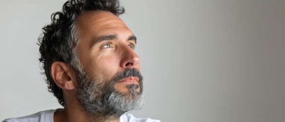 Obraz premium Man With Grey Beard Looking Up in Thought