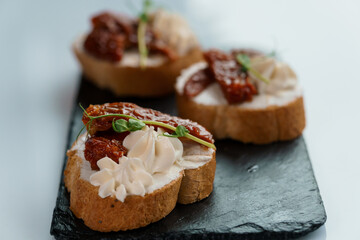 Canapes with sun-dried tomato and salami