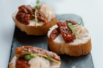 Canapes with sun-dried tomato and salami