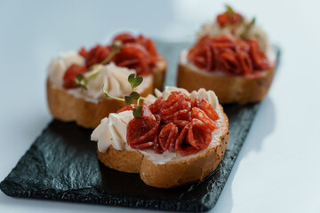 Canapes with sun-dried tomato and salami