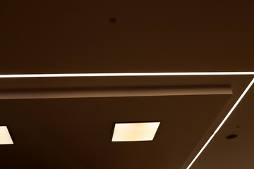 A lamp for illuminating the interior of the room hangs on the ceiling.