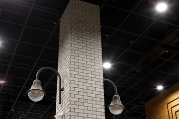 A lamp for illuminating the interior of the room hangs on the ceiling.