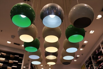 A lamp for illuminating the interior of the room hangs on the ceiling.