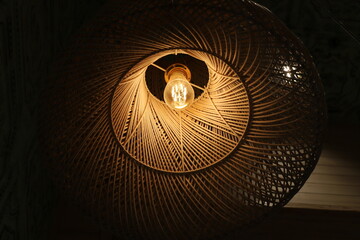 A lamp for illuminating the interior of the room hangs on the ceiling.