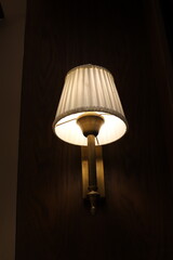 A lamp for illuminating the interior of the room hangs on the ceiling.