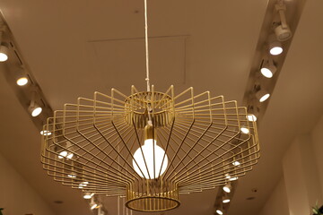 A lamp for illuminating the interior of the room hangs on the ceiling.