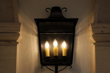 A lamp for illuminating the interior of the room hangs on the ceiling.