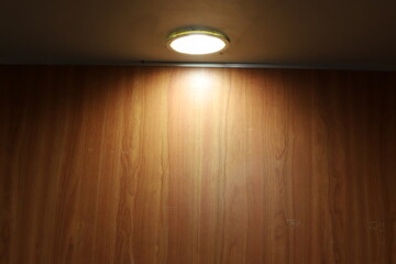 A lamp for illuminating the interior of the room hangs on the ceiling.