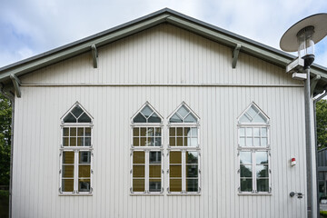 Ratzeburg town library in the building of a former sports hall, light gray painted wooden facade with mullioned windows in historical style, northern Germany