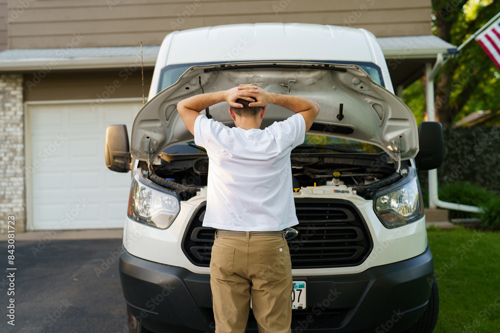 Wall mural stressed man having trouble with his broken car looking in frustration at failed engine