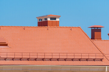 house with a roof from a red shingles with a pipe